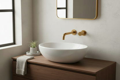 Bathroom scene with matching brushed-gold faucet, handle, and mirror frame