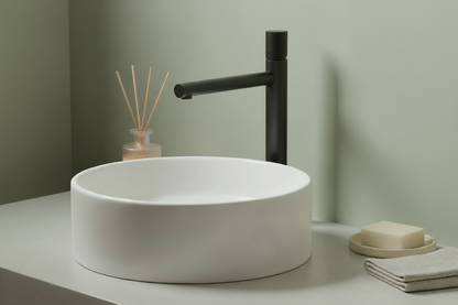 Bathroom with a reed diffuser beside the towel