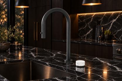 Kitchen scene with black marble countertop and backsplash with white veining